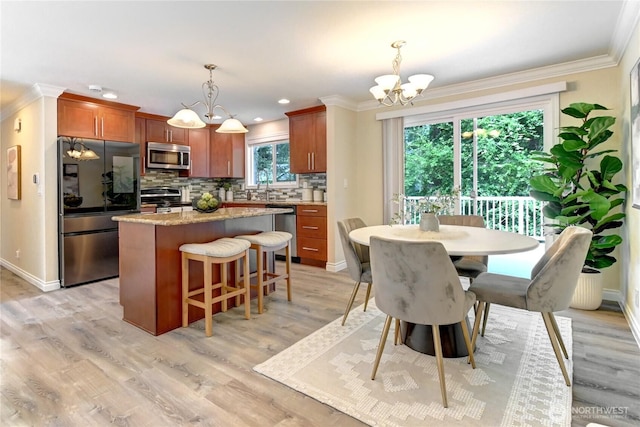 26309 187th Ct SE, Covington, WA 98042 - dining space featuring a chandelier, crown molding, light wood-style flooring, baseboards, and recessed lighting