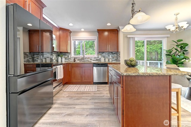 26309 187th Ct SE, Covington, WA 98042 - kitchen featuring freestanding refrigerator, stainless steel dishwasher, a kitchen breakfast bar, light stone countertops, and a sink