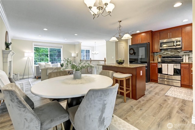 26309 187th Ct SE, Covington, WA 98042 - dining space with a chandelier, light wood-style flooring, ornamental molding, and recessed lighting