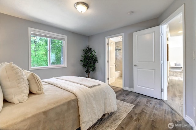26309 187th Ct SE, Covington, WA 98042 - bedroom featuring wood finished floors, ensuite bathroom, and baseboards
