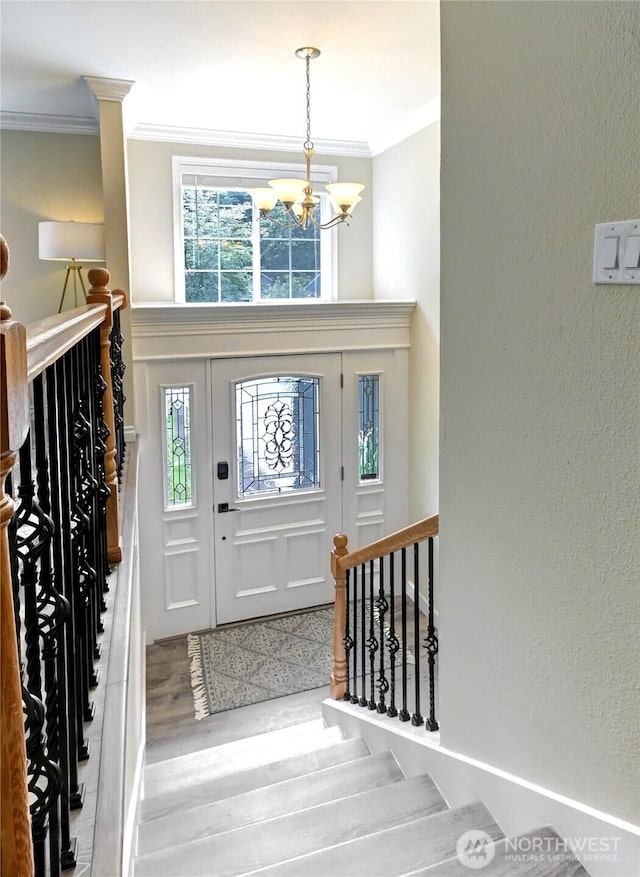26309 187th Ct SE, Covington, WA 98042 - entryway with crown molding, a chandelier, wood finished floors, and a textured wall