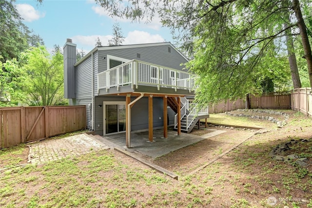 26309 187th Ct SE, Covington, WA 98042 - back of house with a deck, a patio, a fenced backyard, a chimney, and stairs