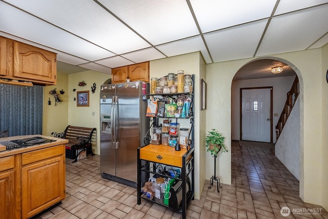 517 Marginal Way, Quincy, WA 98848 - kitchen with stainless steel fridge with ice dispenser, black electric cooktop, arched walkways, and brown cabinets