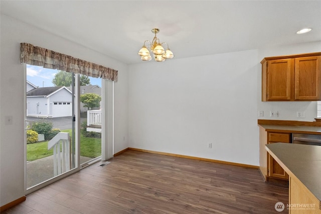 1114 Sinclair Way Unit 63, Burlington, WA 98233 - unfurnished dining area featuring a chandelier, wood finished floors, baseboards, and recessed lighting