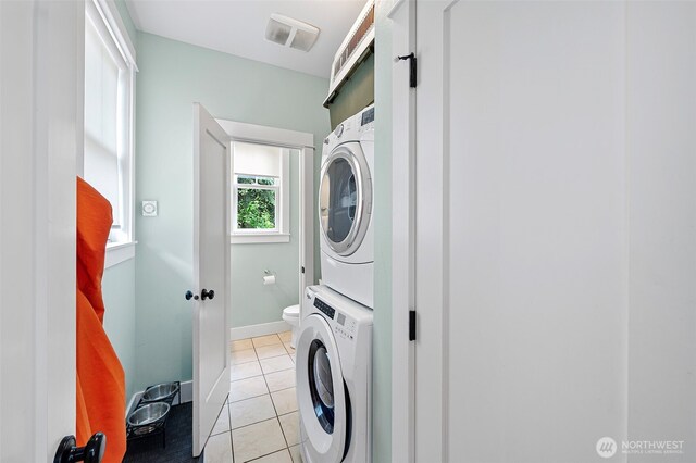 251 Meriweather St, Pacific Beach, WA 98571 - washroom with stacked washer and clothes dryer, light tile patterned floors, and baseboards