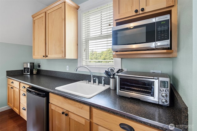 251 Meriweather St, Pacific Beach, WA 98571 - kitchen with stainless steel microwave, a sink, dark countertops, light brown cabinetry, and dishwashing machine