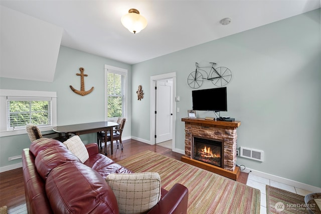 251 Meriweather St, Pacific Beach, WA 98571 - living area featuring plenty of natural light, a stone fireplace, and baseboards