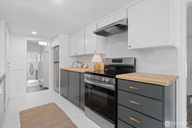 6709 E I St, Tacoma, WA 98404 - kitchen with appliances with stainless steel finishes, gray cabinets, under cabinet range hood, butcher block countertops, and recessed lighting