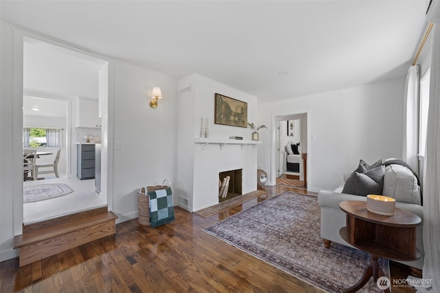 6709 E I St, Tacoma, WA 98404 - living area with dark wood-style flooring and a brick fireplace