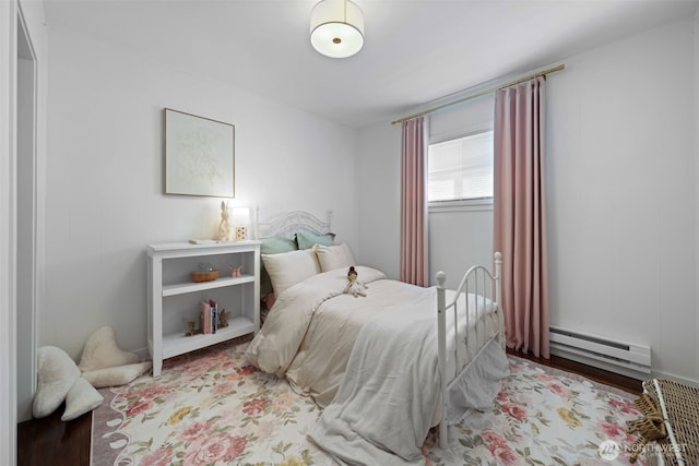 6709 E I St, Tacoma, WA 98404 - bedroom with a baseboard heating unit and wood finished floors