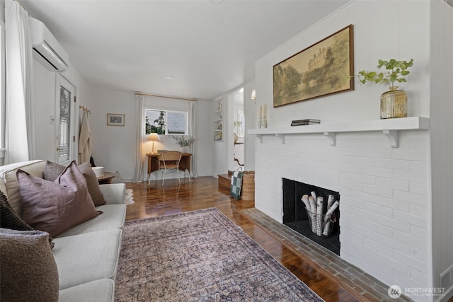 6709 E I St, Tacoma, WA 98404 - living area featuring wood finished floors, a brick fireplace, and a wall unit AC