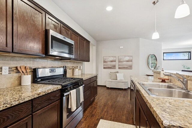 1310 Maple Ave, Snohomish, WA 98290 - kitchen with stainless steel appliances, dark wood-type flooring, dark brown cabinets, tasteful backsplash, and recessed lighting