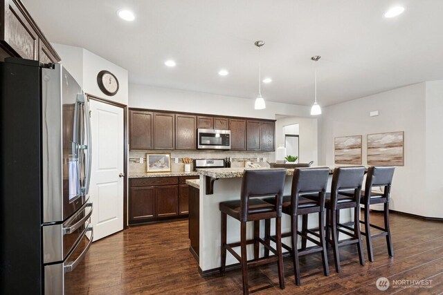 1310 Maple Ave, Snohomish, WA 98290 - kitchen featuring appliances with stainless steel finishes, dark brown cabinets, dark wood-style floors, tasteful backsplash, and recessed lighting