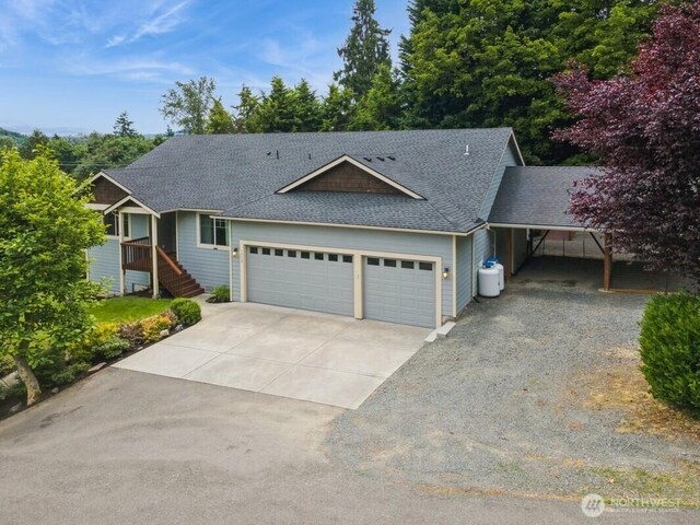 1310 Maple Ave, Snohomish, WA 98290 - view of front of home with concrete driveway, roof with shingles, an attached garage, and stairway