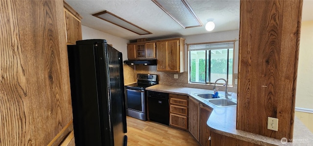 82 Marjory Ln, Sequim, WA 98382 - kitchen with black appliances, under cabinet range hood, a sink, light wood-type flooring, and light countertops