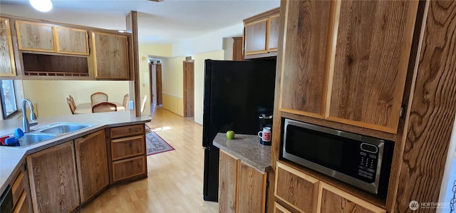 82 Marjory Ln, Sequim, WA 98382 - kitchen featuring stainless steel microwave, freestanding refrigerator, light wood-type flooring, and a sink