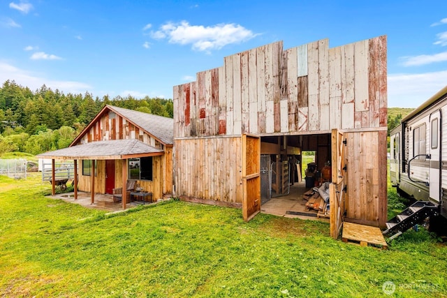 5809 162nd Ave E, Sumner, WA 98390 - back of house with an outdoor structure and a yard