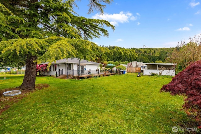 5809 162nd Ave E, Sumner, WA 98390 - view of green lawn featuring a deck and a view of trees