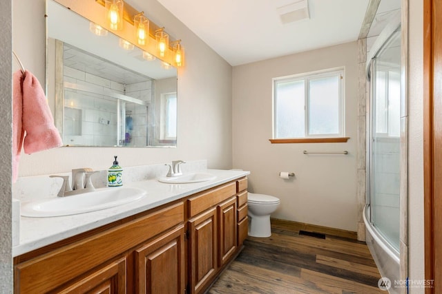 5809 162nd Ave E, Sumner, WA 98390 - full bathroom featuring healthy amount of natural light, wood finished floors, toilet, and double vanity