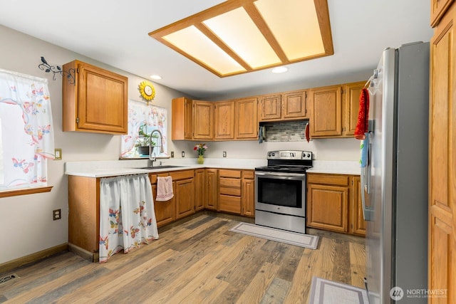 5809 162nd Ave E, Sumner, WA 98390 - kitchen featuring stainless steel appliances, a sink, wood finished floors, recessed lighting, and light countertops