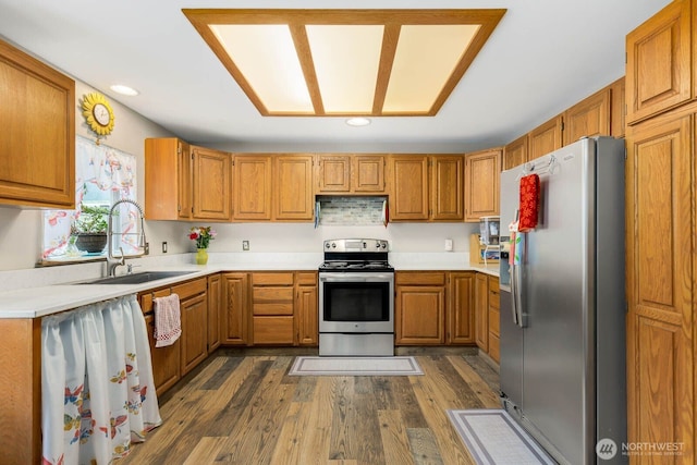 5809 162nd Ave E, Sumner, WA 98390 - kitchen with stainless steel appliances, a sink, brown cabinets, light countertops, and dark wood finished floors
