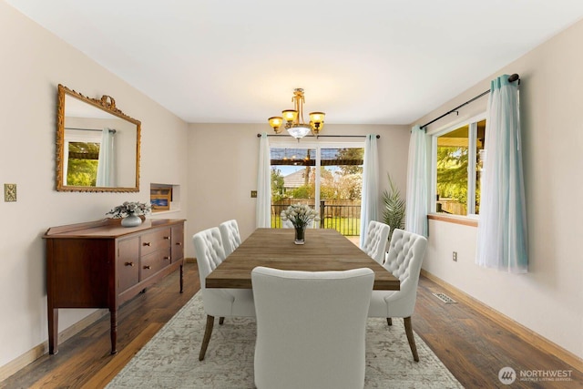 5809 162nd Ave E, Sumner, WA 98390 - dining area featuring wood finished floors, a chandelier, and baseboards