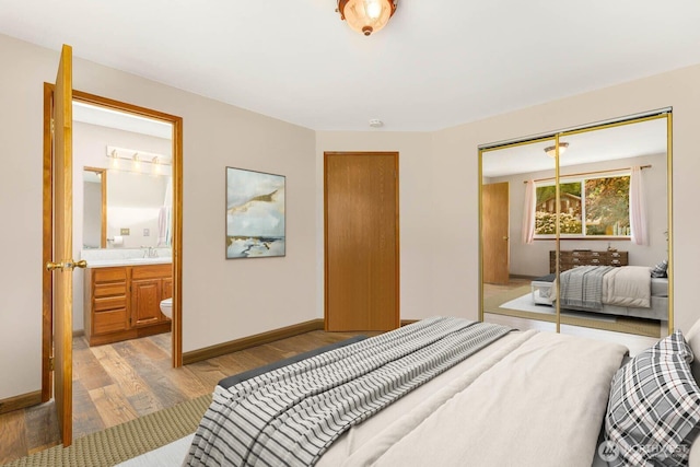 5809 162nd Ave E, Sumner, WA 98390 - bedroom with light wood-style flooring, a closet, baseboards, and ensuite bath