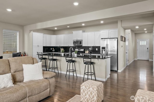 8657 Atlas Ave NE, Lacey, WA 98516 - living area featuring dark wood-style flooring, recessed lighting, and baseboards