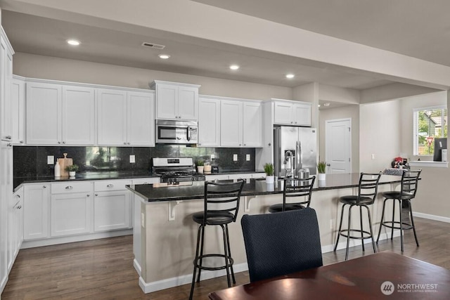 8657 Atlas Ave NE, Lacey, WA 98516 - kitchen featuring appliances with stainless steel finishes, dark countertops, white cabinetry, tasteful backsplash, and recessed lighting