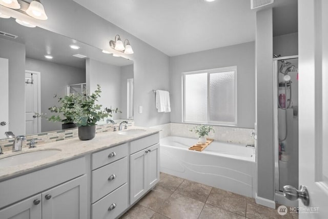 8657 Atlas Ave NE, Lacey, WA 98516 - bathroom featuring a shower stall, a bath, double vanity, and decorative backsplash