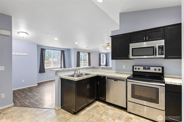 600 S County Rd, Warden, WA 98857 - kitchen with appliances with stainless steel finishes, a sink, a peninsula, baseboards, and recessed lighting