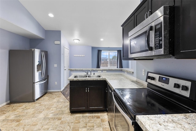 600 S County Rd, Warden, WA 98857 - kitchen with appliances with stainless steel finishes, a sink, light countertops, baseboards, and stone finish flooring