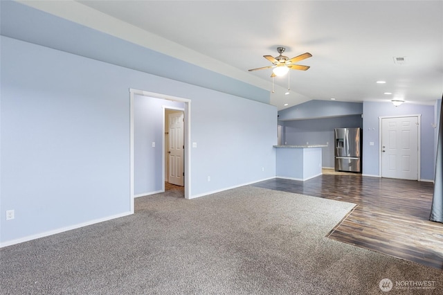 600 S County Rd, Warden, WA 98857 - unfurnished living room featuring dark carpet, lofted ceiling, ceiling fan, baseboards, and dark wood-style floors