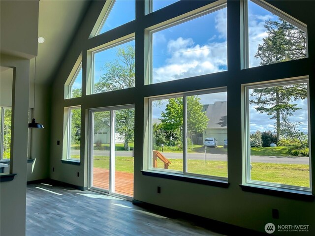 322 Fathom St NE, Ocean Shores, WA 98569 - doorway to outside featuring healthy amount of natural light, wood finished floors, a high ceiling, and baseboards