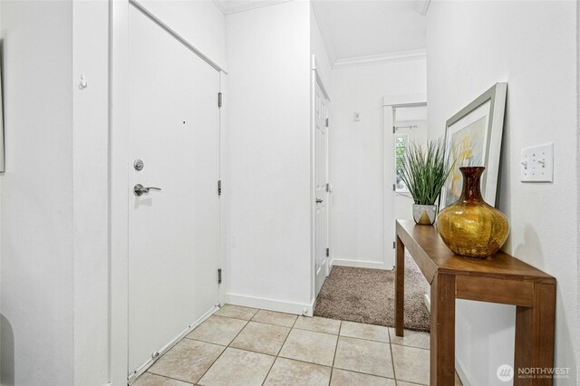 25025 SE Klahanie Blvd Unit D204, Sammamish, WA 98029 - entryway featuring light tile patterned flooring, crown molding, and baseboards