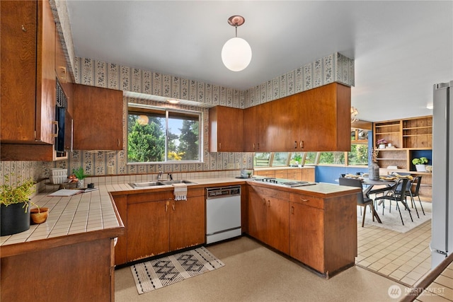 907 Baker St, Bellingham, WA 98225 - kitchen with white appliances, tile countertops, a sink, brown cabinets, and plenty of natural light