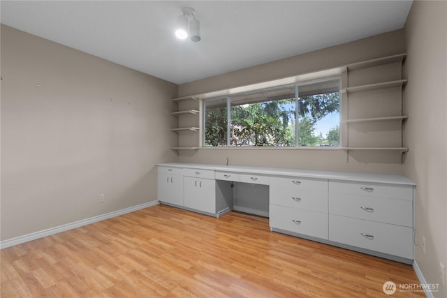 907 Baker St, Bellingham, WA 98225 - unfurnished office with light wood-style flooring, built in study area, and baseboards