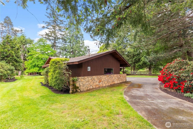 907 Baker St, Bellingham, WA 98225 - view of property exterior with concrete driveway, a lawn, and stone siding