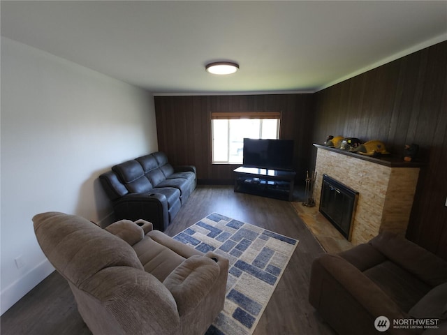 116 W 4th, Port Angeles, WA 98362 - living room with wood finished floors, a stone fireplace, and wood walls