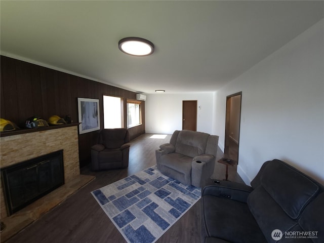 116 W 4th, Port Angeles, WA 98362 - living area with wood finished floors, a fireplace, a wall mounted AC, and wooden walls