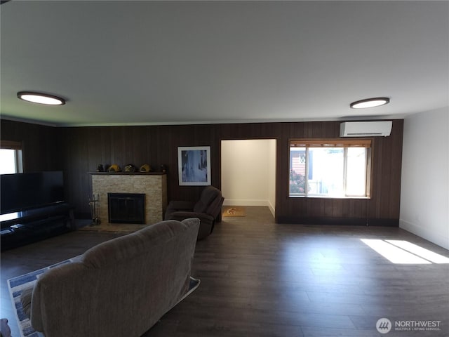 116 W 4th, Port Angeles, WA 98362 - living room featuring a fireplace, dark wood-style floors, a wall mounted AC, and wooden walls