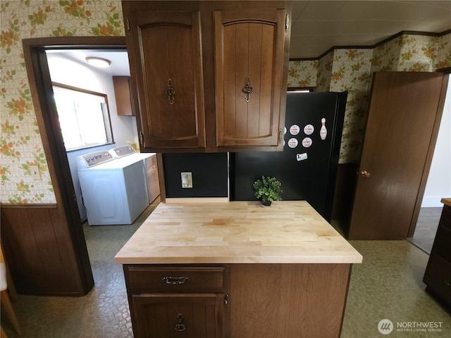 116 W 4th, Port Angeles, WA 98362 - kitchen with wallpapered walls, washer and clothes dryer, butcher block counters, and freestanding refrigerator