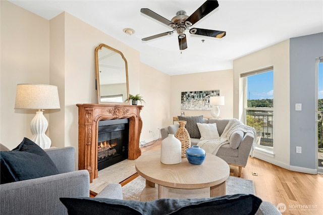 701 Galer St Unit 808, Seattle, WA 98109 - living room with ceiling fan, light wood-type flooring, a glass covered fireplace, and baseboards