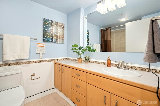 701 Galer St Unit 808, Seattle, WA 98109 - full bathroom featuring vanity, toilet, tile patterned flooring, and a shower with shower curtain