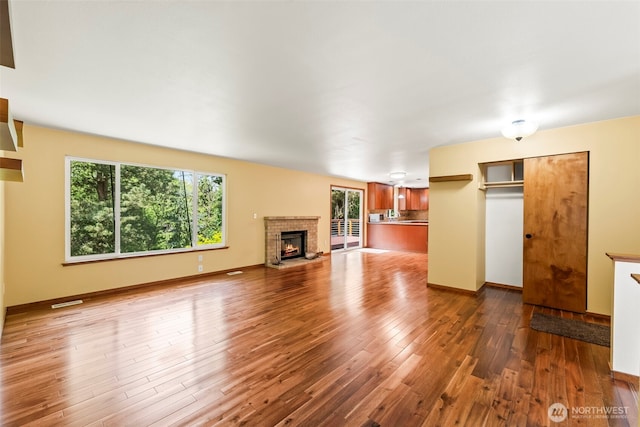 4528 SW 316th Pl, Federal Way, WA 98023 - unfurnished living room featuring a fireplace, wood finished floors, and baseboards