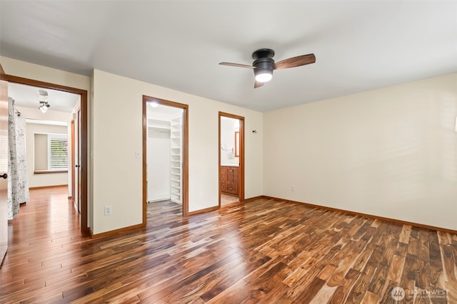 4528 SW 316th Pl, Federal Way, WA 98023 - unfurnished bedroom with dark wood-style floors, a walk in closet, a closet, baseboards, and ceiling fan