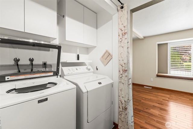 4528 SW 316th Pl, Federal Way, WA 98023 - washroom with independent washer and dryer, cabinet space, wood finished floors, and baseboards