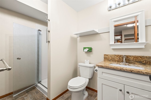 4528 SW 316th Pl, Federal Way, WA 98023 - full bathroom featuring vanity, a stall shower, toilet, stone finish flooring, and baseboards