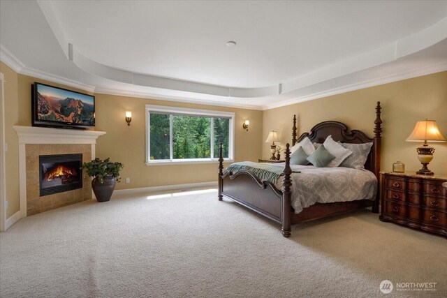 31045 219th Way SE, Black Diamond, WA 98010 - carpeted bedroom featuring a raised ceiling, a fireplace, ornamental molding, and baseboards