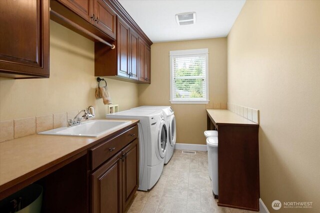 31045 219th Way SE, Black Diamond, WA 98010 - laundry area with washing machine and clothes dryer, baseboards, and cabinet space
